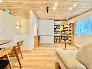 a living room with a couch and a table at BookHouse in Takasaki