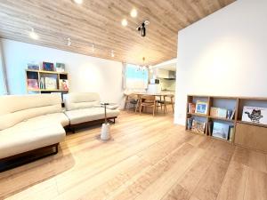 a living room with a couch and a table at BookHouse in Takasaki