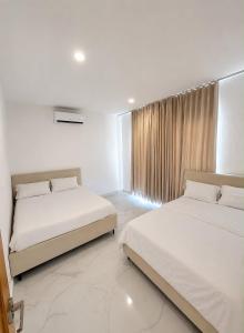 a bedroom with two beds and a window at Villa costa mar in Cabrera