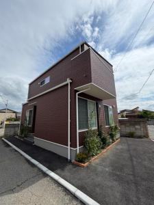 a brown brick building with a lot of windows at BookHouse in Takasaki