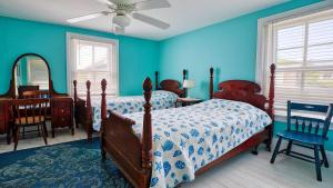 a bedroom with a bed and a table and chairs at Victorian On North in Cape May