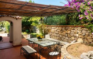 a patio with a table and chairs and a stone wall at Villa Marina in Anacapri +28 photos