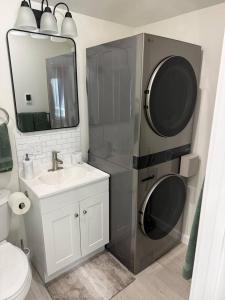 a bathroom with a sink and a washing machine at Modern Private Studio - Separate Entry in Edgewood +11 photos