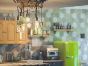 a chandelier in a kitchen hanging from the ceiling at greet hôtel Annecy Cran-Gevrier by Accor in Annecy