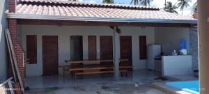 a pavilion with a bench on the side of a house at beach house in Pontal de Coruripe in Coruripe