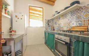 a kitchen with a stove and a refrigerator at L'antica Pietra in Perdifumo