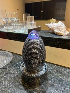 a black and white vase sitting on a counter at Vista mar nascente in São Luís
