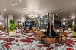 a row of video game consoles in a room at Hotel Allen in Townsville