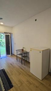 an empty room with a table and a refrigerator at Casa Mango Jardin in San Francisco +24 photos