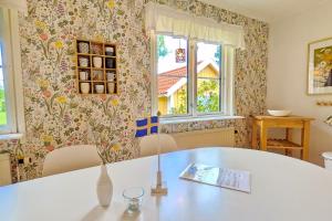 a room with a table and two windows at "Hasselbacken" in Vimmerby
