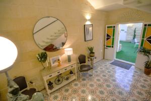 a room with a mirror and a table and chairs at Villa Dar Tfuliti in San Lawrenz