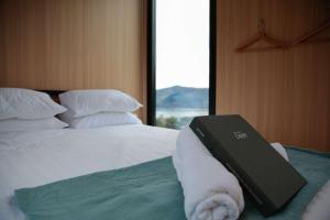 a laptop sitting on top of a bed with a window at Bayview Paradise by Tiny Away in Diamond Harbour