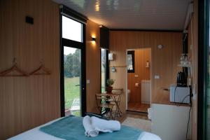 a bedroom with a bed with towels on it at Bayview Paradise by Tiny Away in Diamond Harbour