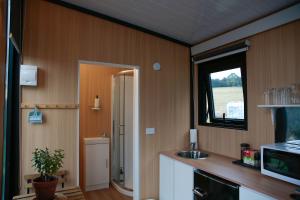a kitchen with a sink and a window at Bayview Paradise by Tiny Away in Diamond Harbour