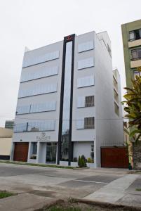 a large white building on the side of a street at Flamante Hotel & Suite in Lima