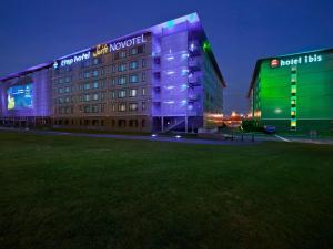a hotel building with a lit up facade at night at hotelF1 Roissy CDG Pn2 in Roissy-en-France