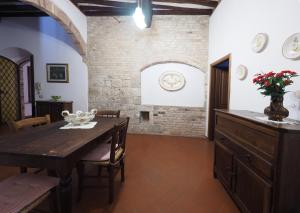a dining room with a table and a brick wall at Antica Posta in San Gimignano