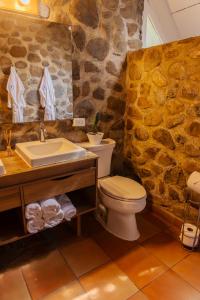 a stone bathroom with a toilet and a sink at La Dama de los vientos in Cerro Azul +97 photos