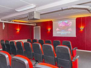 an empty room with red walls and red chairs at 6 person holiday home in Glesborg in Glesborg +52 photos