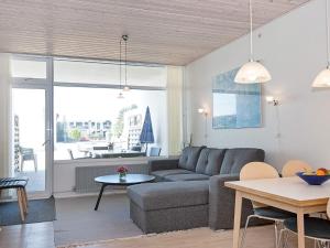 a living room with a couch and a table at 6 person holiday home in Glesborg in Glesborg