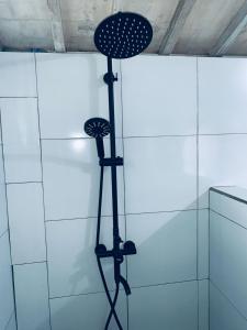 a stand up shower in a bathroom with white tiles at Bulan Bungalows and Cafe in Tetebatu +31 photos