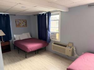 a small room with a bed and a window at Hammock Inn & Suites North Beach Hotel in Seaside Heights +31 photos