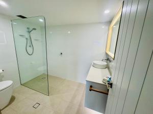 a bathroom with a shower and a toilet at Northpoint Apartments in Port Macquarie