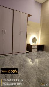 a bathroom with a sink and a mirror at Minihouse Út Thiểu in Rạch Giá