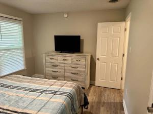 a bedroom with a bed and a television on a dresser at Twin Oaks Haven in Murfreesboro
