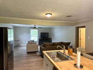 a kitchen and living room with a sink and a couch at Twin Oaks Haven in Murfreesboro