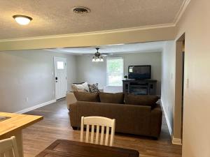 a living room with a couch and a tv at Twin Oaks Haven in Murfreesboro