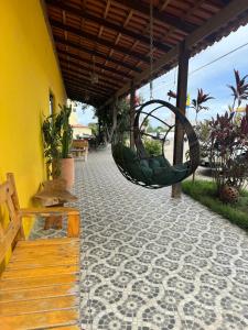 a patio with a swing hanging from a building at Hotel Mandacaru in Piranhas