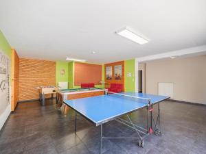 a ping pong room with a ping pong table at Moderscheid Cottage with Spa in Amblève
