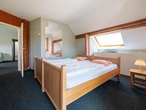 a bedroom with two beds and a window at Moderscheid Cottage with Spa in Amblève