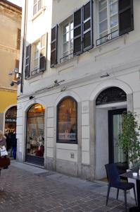 ein weißes Gebäude mit einem Ladenschild im Schaufenster in der Unterkunft CHARMING COMO - Apartment downtown in the pedestrian area with 2 double bedrooms and 2 complete bathrooms a spacious living room and full equipped kitchen in Como