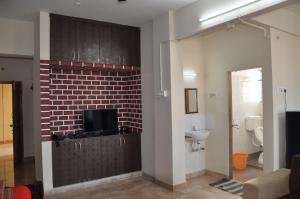 a bathroom with a brick wall and a sink at Nayath Serviced Apartments in Tirupati +62 photos