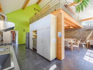 a kitchen with green walls and a table with chairs at Group Getaway in Amel in Amblève