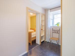 a room with a closet and a chair and a window at Group Getaway in Amel in Amblève +19 photos