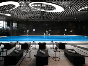 a large room with couches and tables and a pool at Sofitel Guiyang Hunter in Guiyang