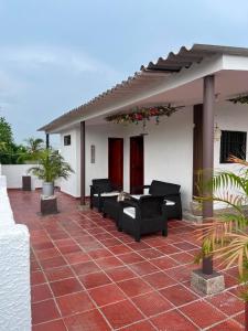 a patio with black furniture on a house at Hotel Sun River in Barranquilla