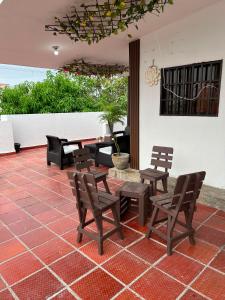 a patio with chairs and a table and a potted plant at Hotel Sun River in Barranquilla