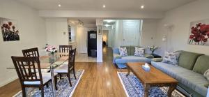 a living room with a couch and a table at Bright 2 BR, Great Location in West Vancouver +4 photos