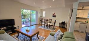 a living room with a couch and a table at Bright 2 BR, Great Location in West Vancouver