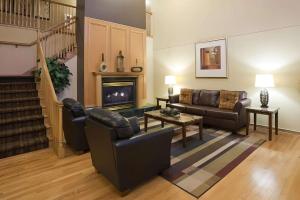 a living room with a couch and a fireplace at Quality Inn & Suites Stillwater in Stillwater