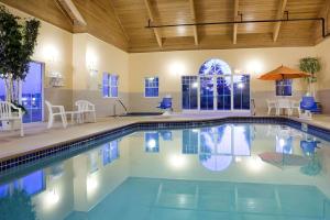 a large swimming pool with blue water in a building at Quality Inn & Suites Stillwater in Stillwater