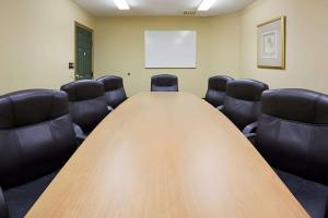 a conference room with a wooden table and leather chairs at Quality Inn & Suites Stillwater in Stillwater