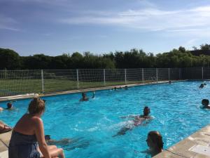 a group of people swimming in a swimming pool at De Haan in De Haan