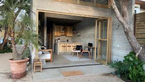 a patio with a kitchen and a table at CASA NU La Saladita surf point in Temalhuacán