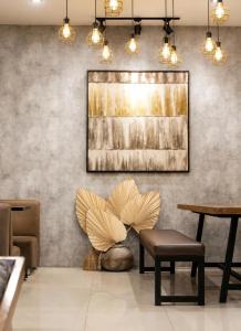 a lobby with a chair and a painting on the wall at Bis Hotel Hồ Chí Minh in Chợ Phước Hải +15 photos