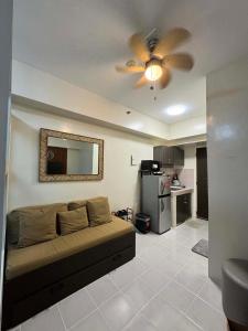 a living room with a couch and a ceiling fan at Maldee's Place Tagaytay Prime Residences in Tagaytay